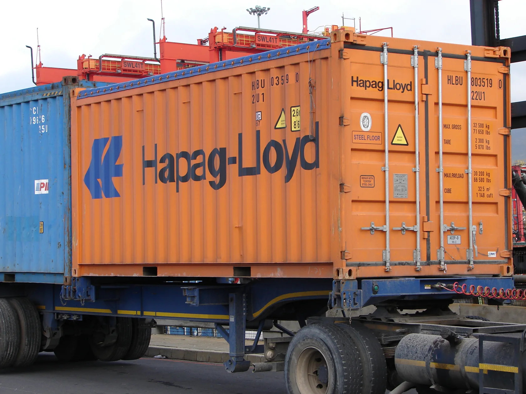Industry photograph of an open top container from the side, showing the tarpaulin and supporting structure.